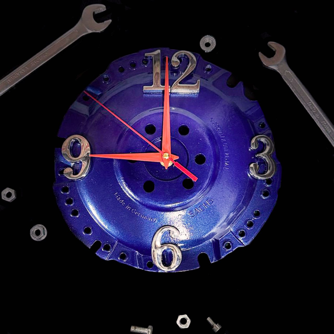Zils industriāls sienas pulkstenis no sajūga diska ar sarkaniem rādītājiem